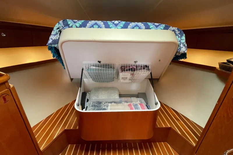 Sasea Yacht Photos Pics 2009 Tiara Yachts 4200 Open interior with under-bed storage and wooden flooring.