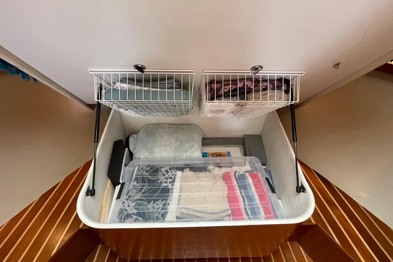 Sasea Yacht Photos Pics 2009 Tiara Yachts 4200 Open storage compartment with organized shelves and containers.