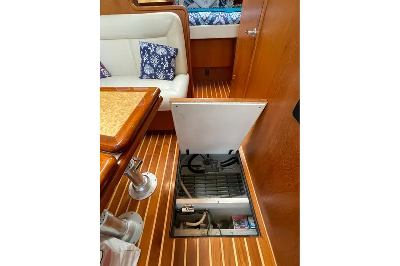 Sasea Yacht Photos Pics 2009 Tiara Yachts 4200 Open interior with open floor hatch, wooden flooring, and seating area.