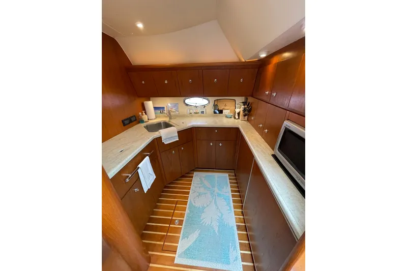 Sasea Yacht Photos Pics Luxurious 2009 Tiara Yachts 4200 Open kitchen with wood cabinetry and modern appliances.