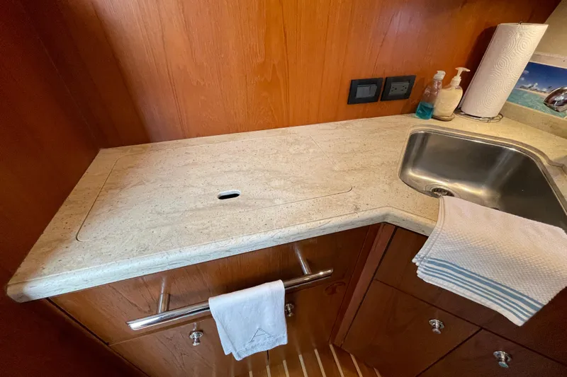 Sasea Yacht Photos Pics 2009 Tiara Yachts 4200 Open galley with sink, countertop, and wooden cabinetry.