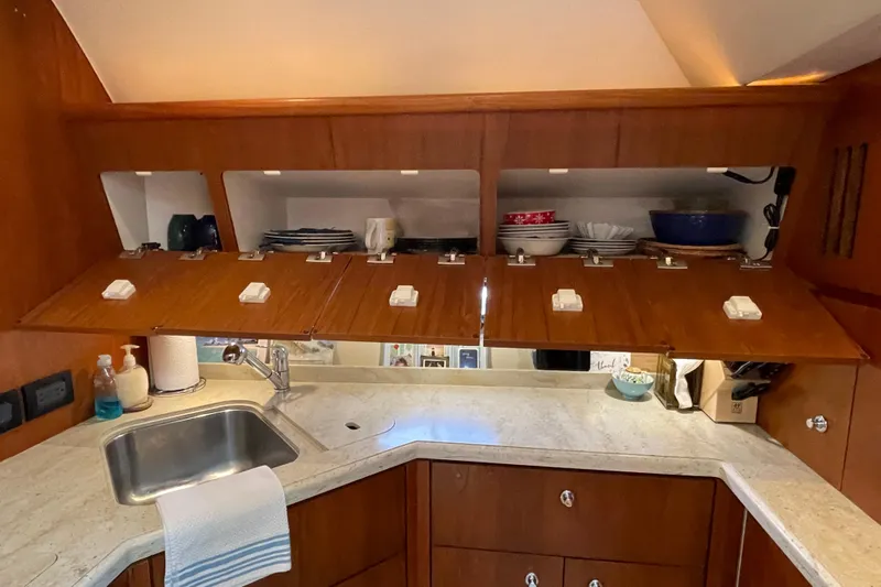 Sasea Yacht Photos Pics 2009 Tiara Yachts 4200 Open kitchen with wooden cabinets and marble countertop.