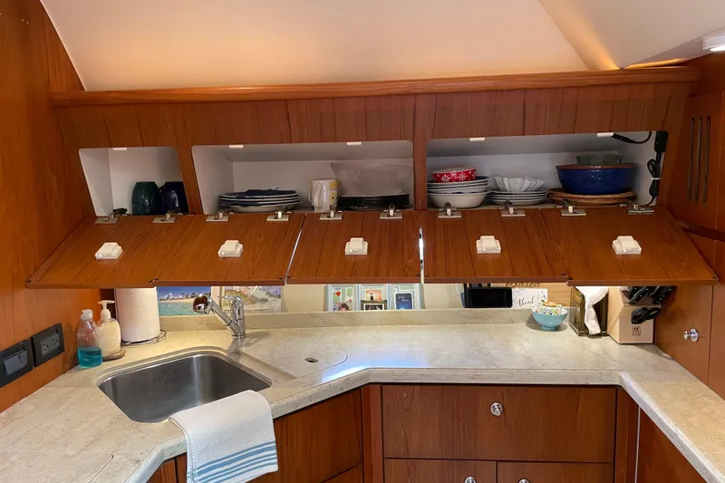 Sasea Yacht Photos Pics Luxurious 2009 Tiara Yachts 4200 Open galley with wooden cabinets and modern amenities.