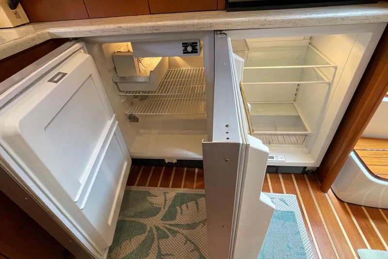 Sasea Yacht Photos Pics Open refrigerator in 2009 Tiara Yachts 4200 Open, showcasing interior storage space.