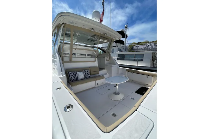 Sasea Yacht Photos Pics 2009 Tiara Yachts 4200 Open, spacious deck with seating and table, under clear blue sky.