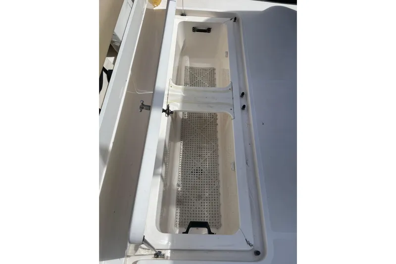 Sasea Yacht Photos Pics 2009 Tiara Yachts 4200 Open storage compartment with white interior and grid design.