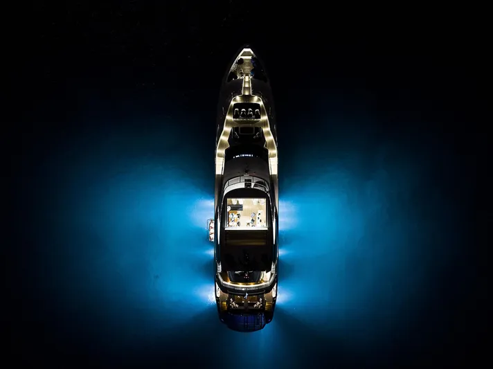 Evereast Yacht Photos Pics Aerial view of 2013 Sunseeker Predator 115 yacht illuminated at night.