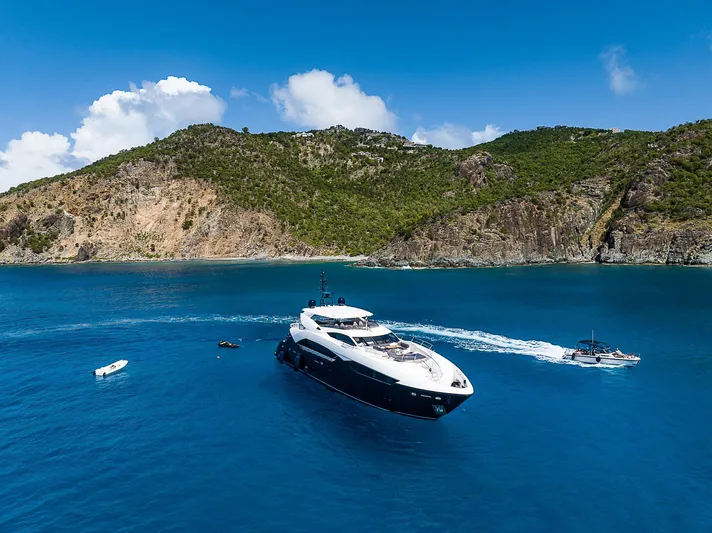 Evereast Yacht Photos Pics 2013 Sunseeker Predator 115 yacht cruising in a scenic bay.