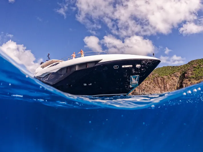 Evereast Yacht Photos Pics 2013 Sunseeker Predator 115 yacht on clear blue water with scenic background.