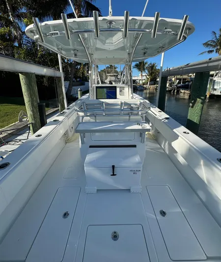  Yacht Photos Pics 2023 Contender 32 ST boat docked, featuring spacious deck and modern design.