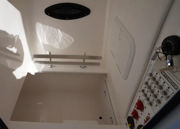  Yacht Photos Pics 2023 Contender 32 ST boat interior with control panel and storage compartment.