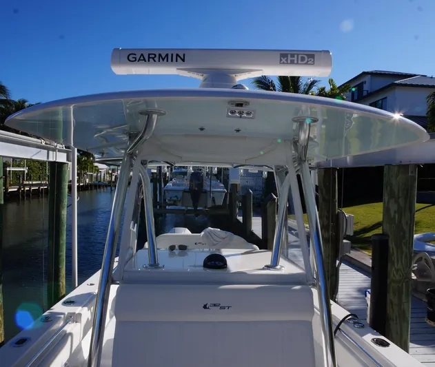  Yacht Photos Pics 2023 Contender 32 ST boat with Garmin xHD2 radar, docked in a sunny marina.