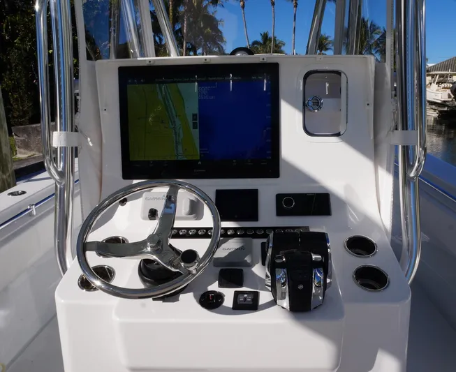  Yacht Photos Pics 2023 Contender 32 ST boat dashboard with steering wheel and navigation display.