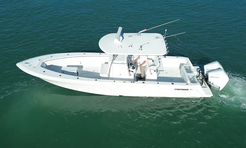  Yacht Photos Pics 2023 Contender 32 ST boat cruising on clear blue water.