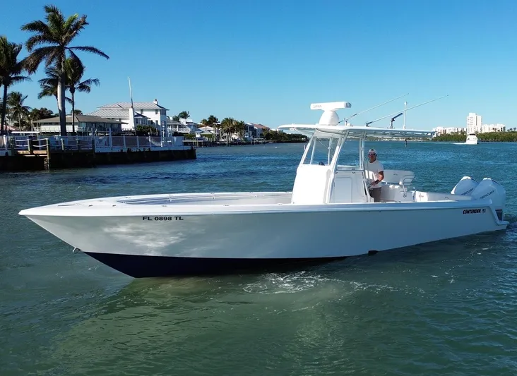  Yacht Photos Pics 2023 Contender 32 ST boat cruising on a sunny waterway.