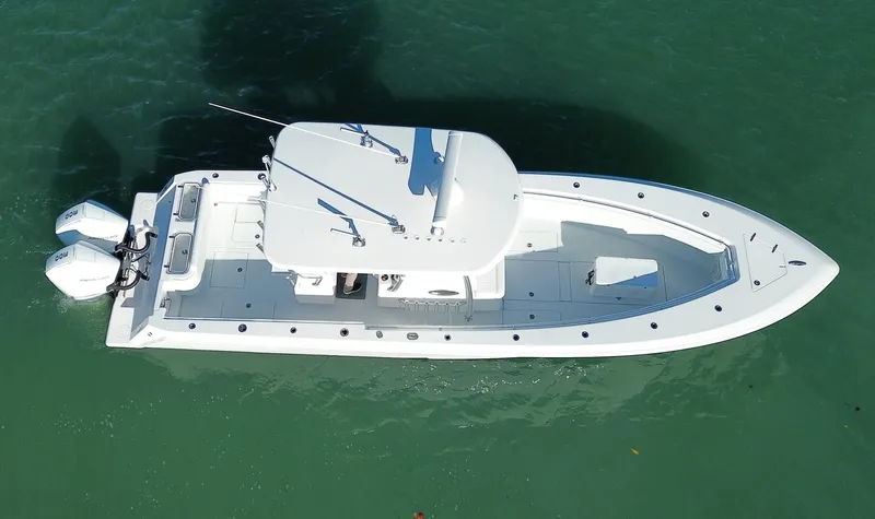  Yacht Photos Pics 2023 Contender 32 ST boat on water, aerial view, sleek design, twin engines.