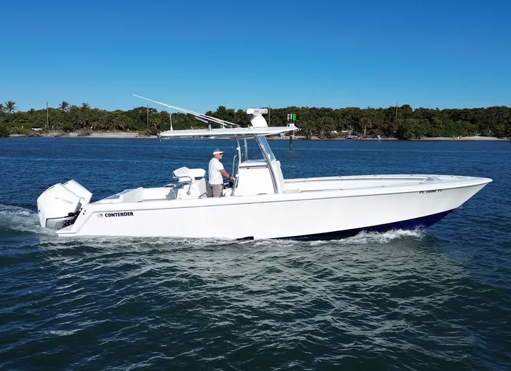  Yacht Photos Pics 2023 Contender 32 ST boat cruising on a sunny day.