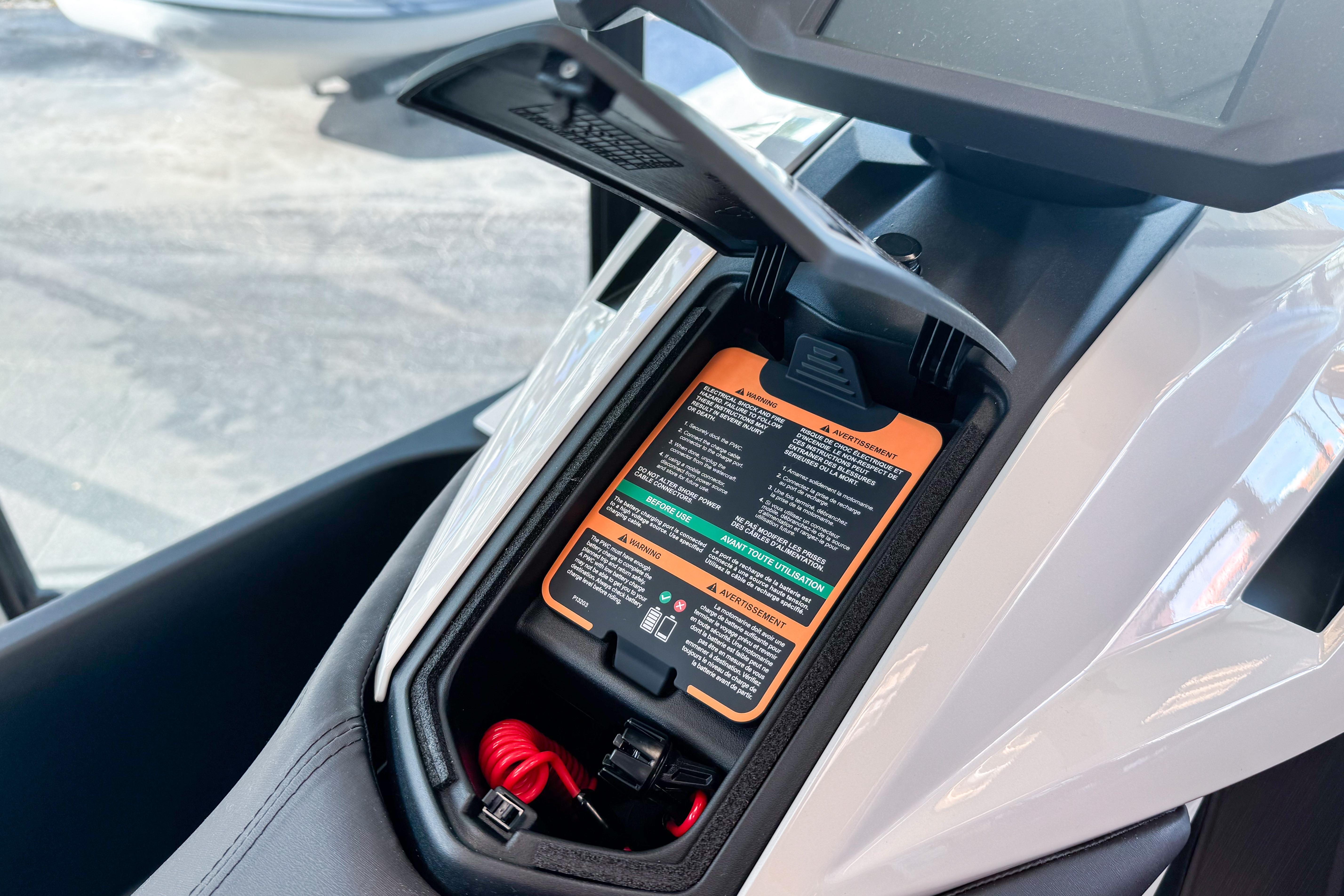 2025 Taiga Orca P2 storage compartment with visible instructions and red cable.