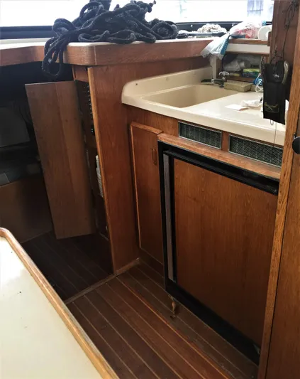 Katama Yacht Photos Pics 1986 Bertram 31 Sportfish Flybridge interior with wooden cabinetry and sink.