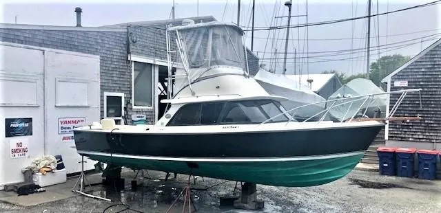 Katama Yacht Photos Pics 1986 Bertram 31 Sportfish Flybridge boat on dry dock at a marina.