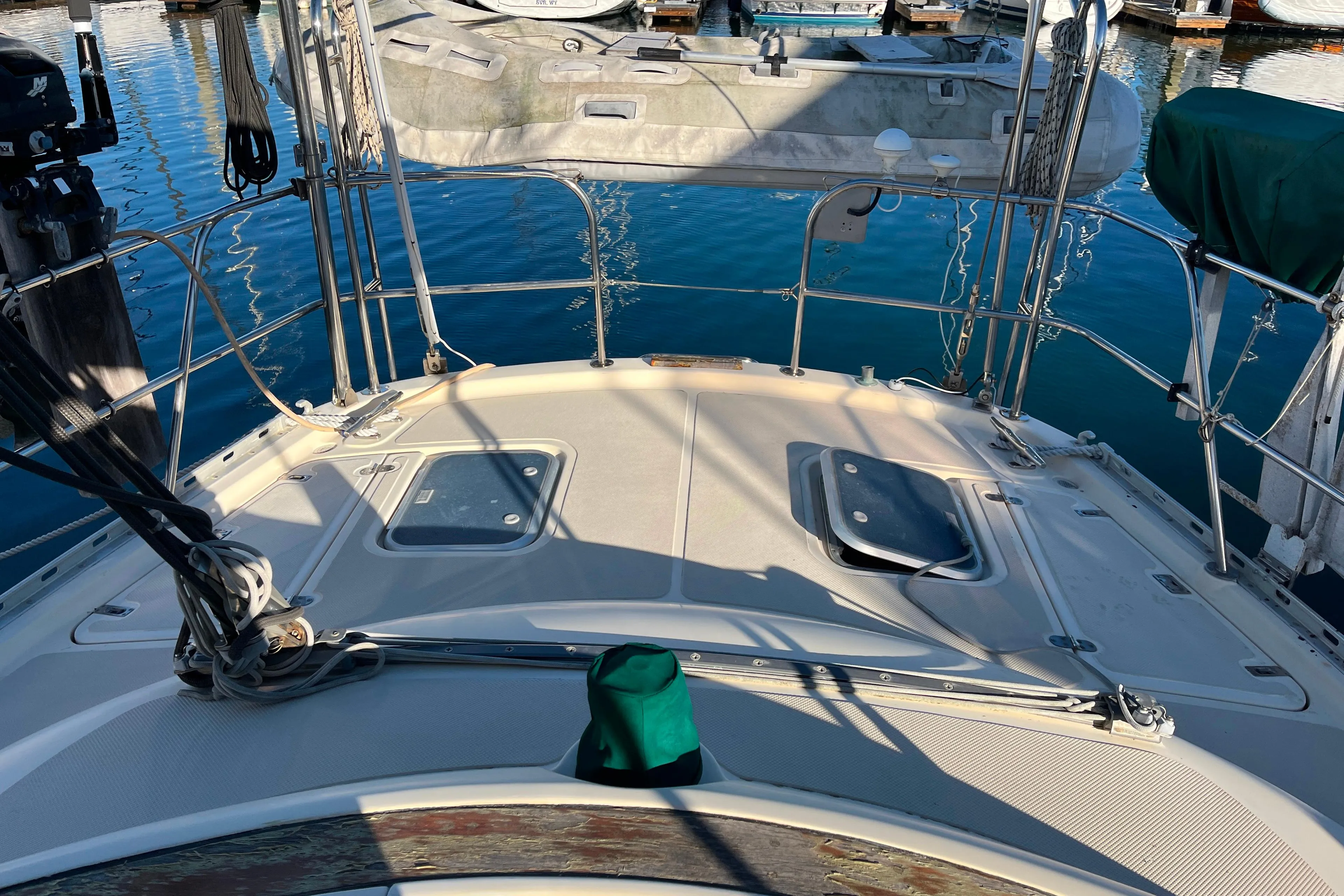 1985 Caliber 47LRC yacht deck with hatches, docked in marina.