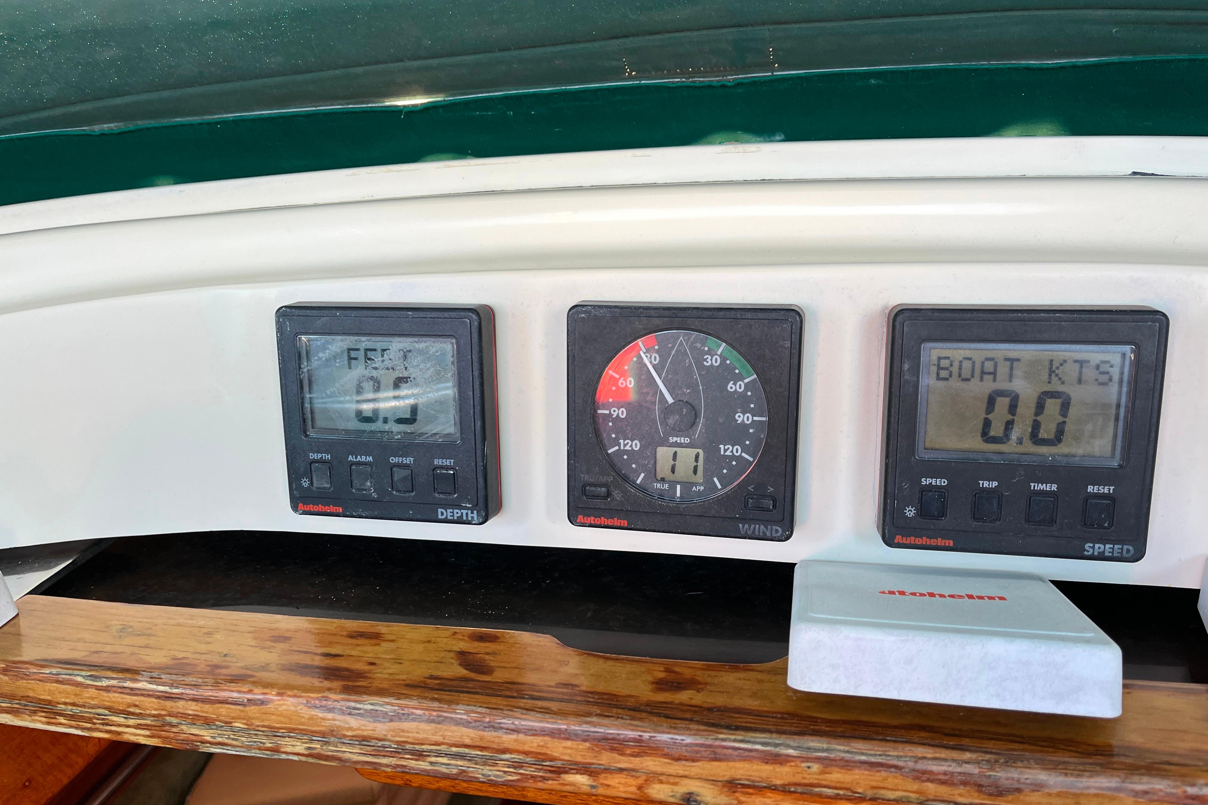 Boat dashboard with depth, wind, and speed gauges on a 1985 Caliber 47LRC.
