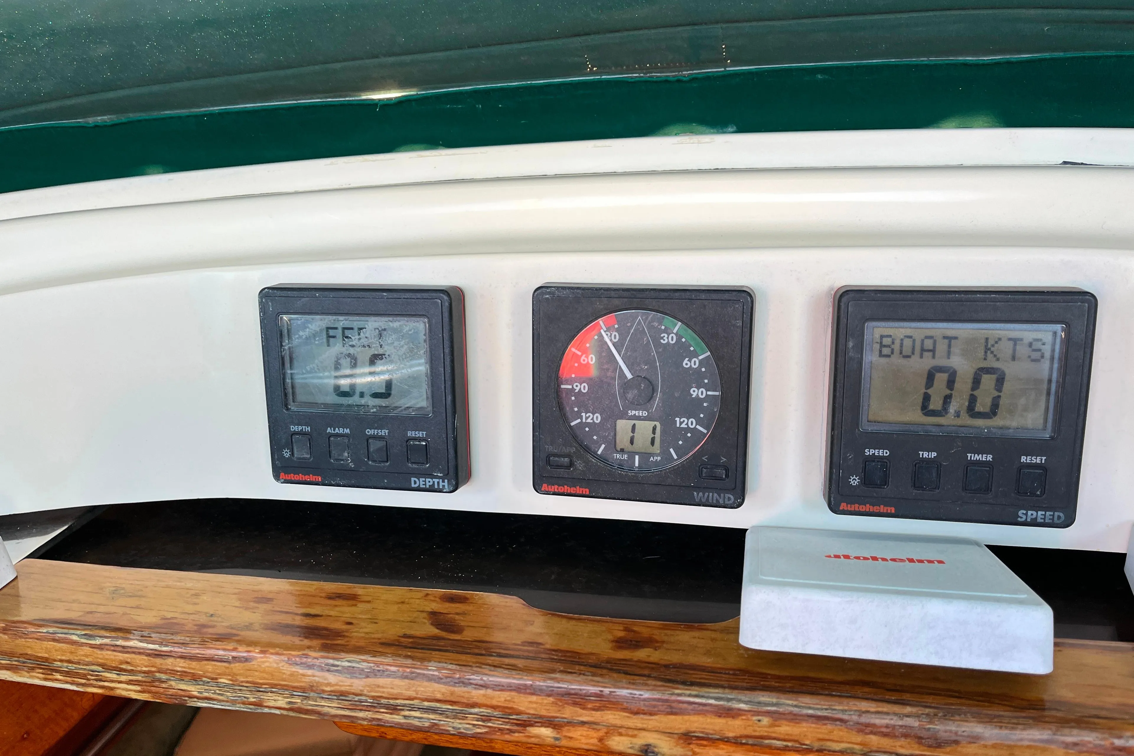 Boat dashboard with depth, wind, and speed gauges on a 1985 Caliber 47LRC.