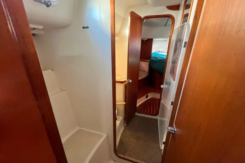"destination Unknown" Yacht Photos Pics Interior of 1985 Caliber 47LRC yacht showing cabin and wooden doors.