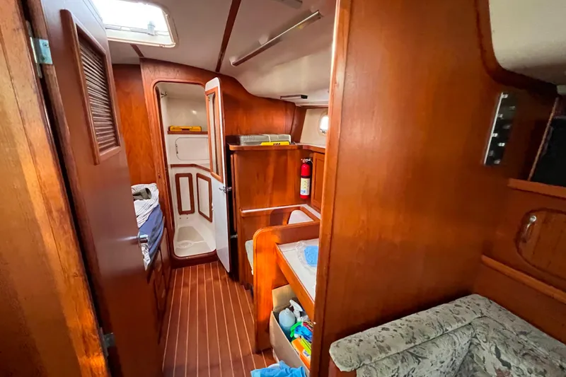 "destination Unknown" Yacht Photos Pics Interior of 1985 Caliber 47LRC yacht with wooden finish and cozy cabin space.