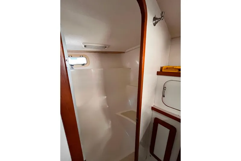 "destination Unknown" Yacht Photos Pics 1985 Caliber 47LRC yacht bathroom with wooden trim and compact design.