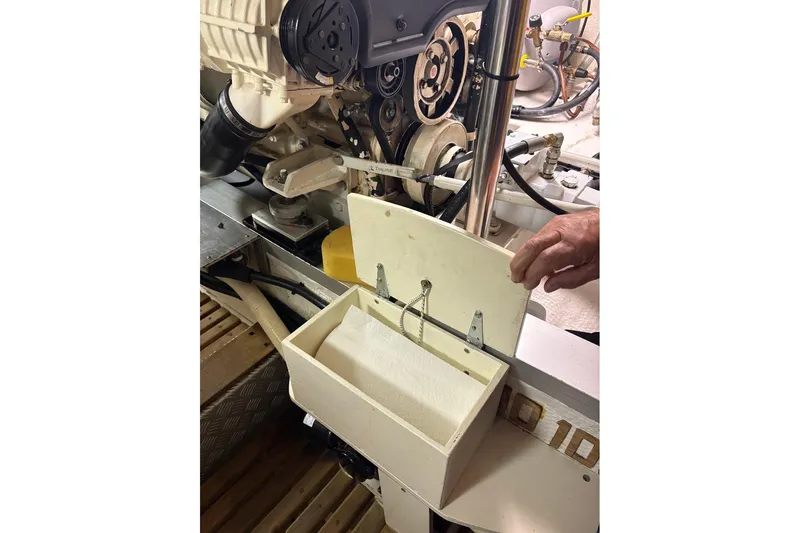 Margo Yacht Photos Pics Engine compartment of 1996 Grand Banks 42 Classic with maintenance tools and paper towel holder.