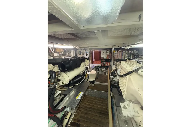 Margo Yacht Photos Pics Engine room of a 1996 Grand Banks 42 Classic yacht, showcasing dual engines and equipment.