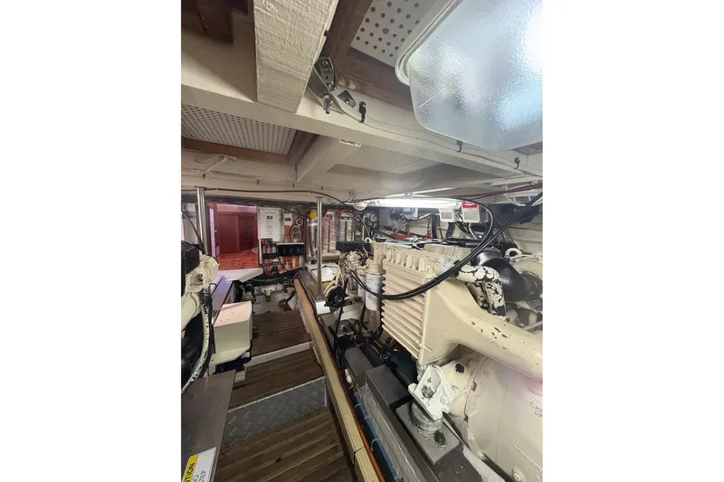 Margo Yacht Photos Pics Engine room of a 1996 Grand Banks 42 Classic yacht, showcasing mechanical components.