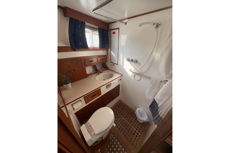 Margo Yacht Photos Pics Bathroom interior of 1996 Grand Banks 42 Classic yacht, featuring sink, toilet, and shower.