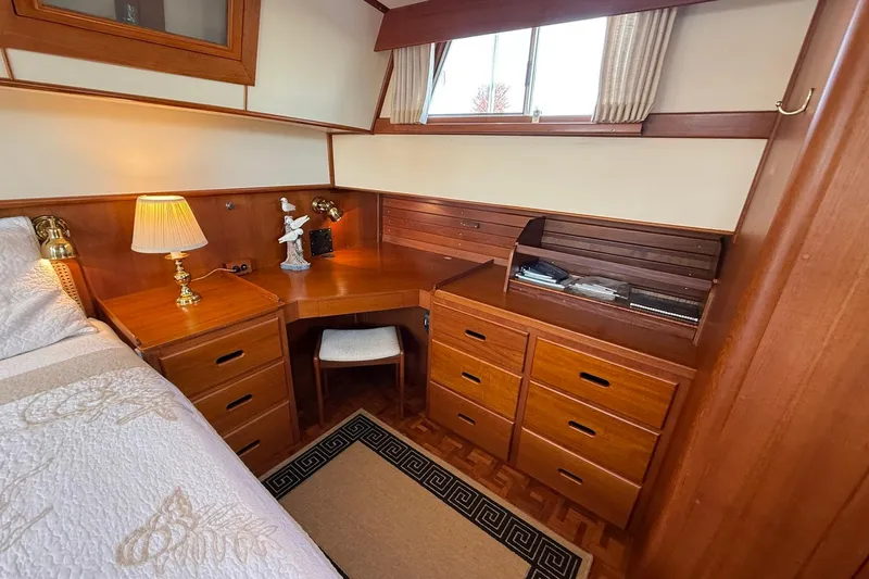 Margo Yacht Photos Pics Cozy cabin interior of 1996 Grand Banks 42 Classic with wooden desk and drawers.