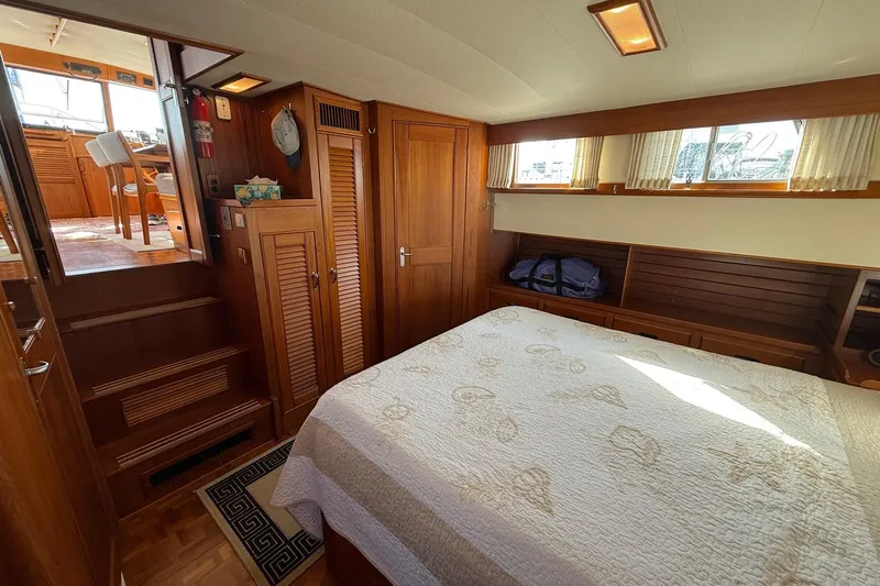 Margo Yacht Photos Pics Cozy bedroom interior of 1996 Grand Banks 42 Classic yacht with wooden furnishings.