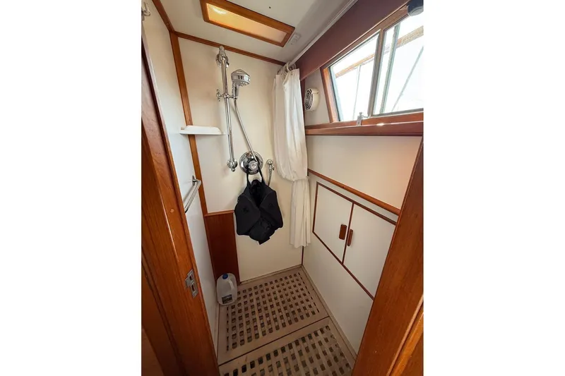 Margo Yacht Photos Pics Shower area in 1996 Grand Banks 42 Classic yacht with wooden accents and window.