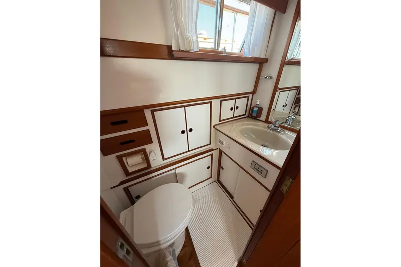 Margo Yacht Photos Pics Bathroom interior of 1996 Grand Banks 42 Classic yacht, featuring sink and toilet.