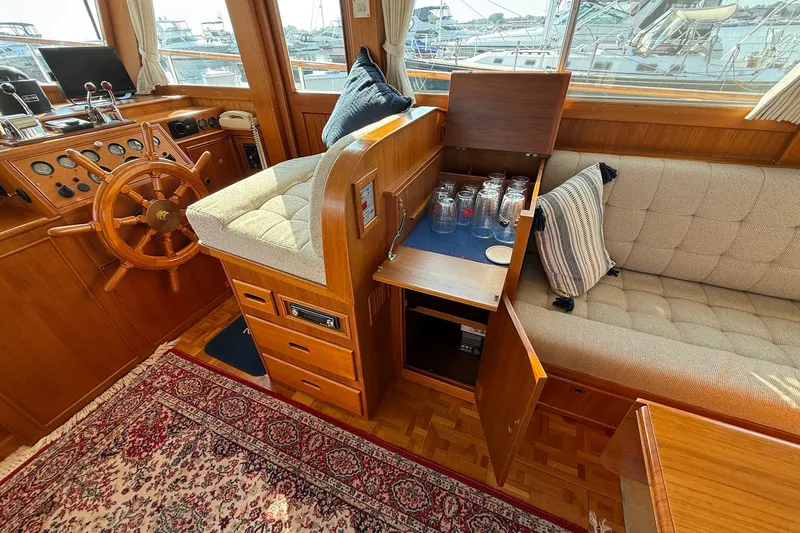 Margo Yacht Photos Pics Interior of 1996 Grand Banks 42 Classic yacht with wooden helm and cozy seating area.
