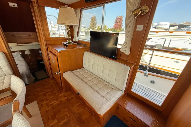Margo Yacht Photos Pics Interior of 1996 Grand Banks 42 Classic yacht with cozy seating and window view.