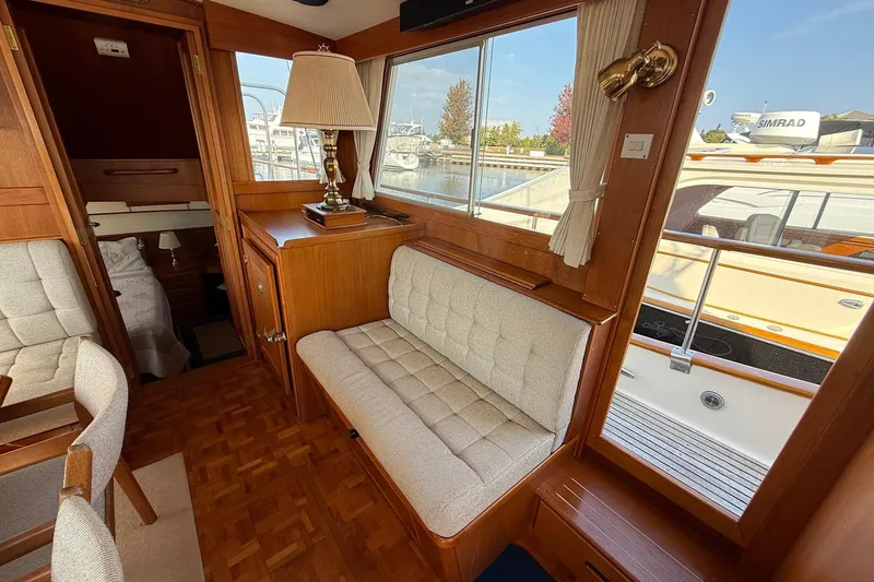 Margo Yacht Photos Pics Interior of 1996 Grand Banks 42 Classic yacht with wood paneling and cushioned seating.