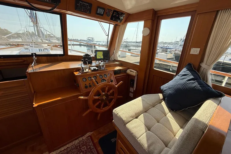 Margo Yacht Photos Pics Helm of 1996 Grand Banks 42 Classic yacht with wooden steering wheel and plush seating.