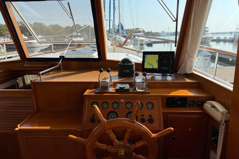 Margo Yacht Photos Pics Helm of 1996 Grand Banks 42 Classic yacht with wooden wheel and navigation equipment.