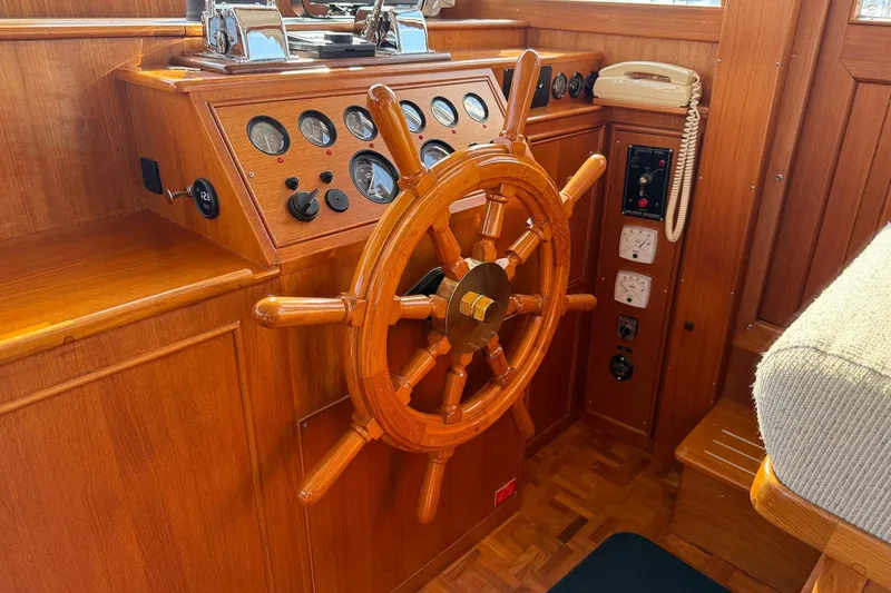 Margo Yacht Photos Pics Wooden helm of a 1996 Grand Banks 42 Classic yacht with gauges and controls.