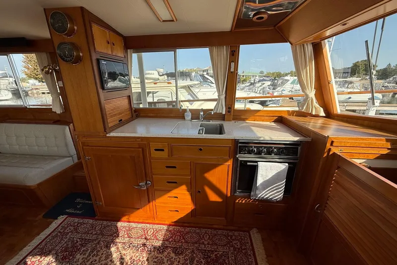 Margo Yacht Photos Pics Interior of 1996 Grand Banks 42 Classic yacht with wooden cabinetry and marina view.