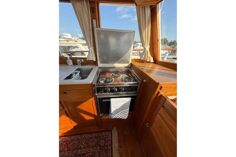 Margo Yacht Photos Pics Galley kitchen in 1996 Grand Banks 42 Classic yacht with stove and sink.
