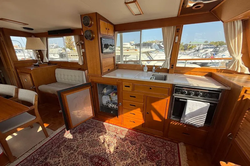 Margo Yacht Photos Pics Interior of a 1996 Grand Banks 42 Classic yacht with wooden cabinetry and kitchen amenities.