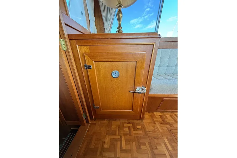 Margo Yacht Photos Pics Wooden interior of 1996 Grand Banks 42 Classic yacht, featuring a small cabinet door.