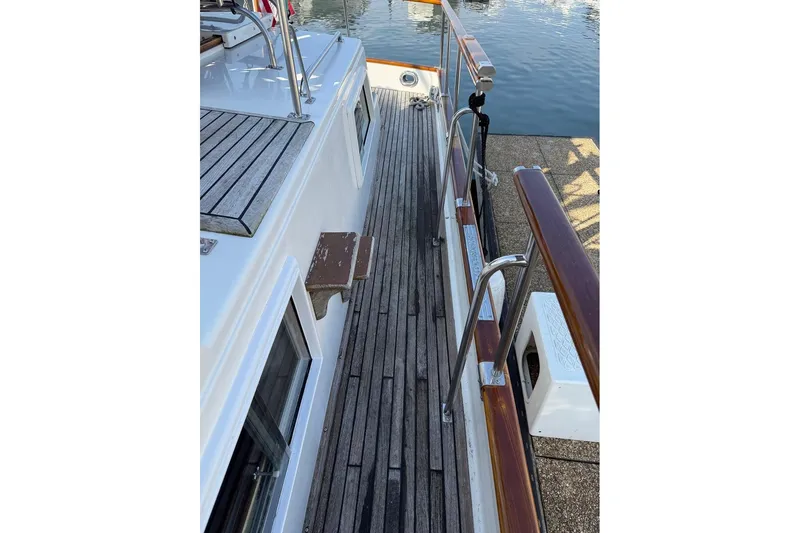 Margo Yacht Photos Pics Side deck of 1996 Grand Banks 42 Classic yacht with wooden railings.