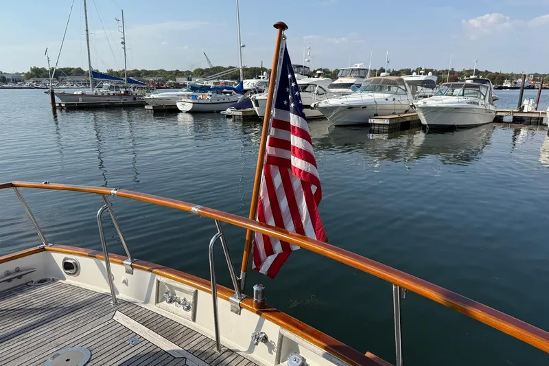 Margo Yacht Photos Pics Grand Banks 42 Classic yacht, 1996, with American flag at marina dock.